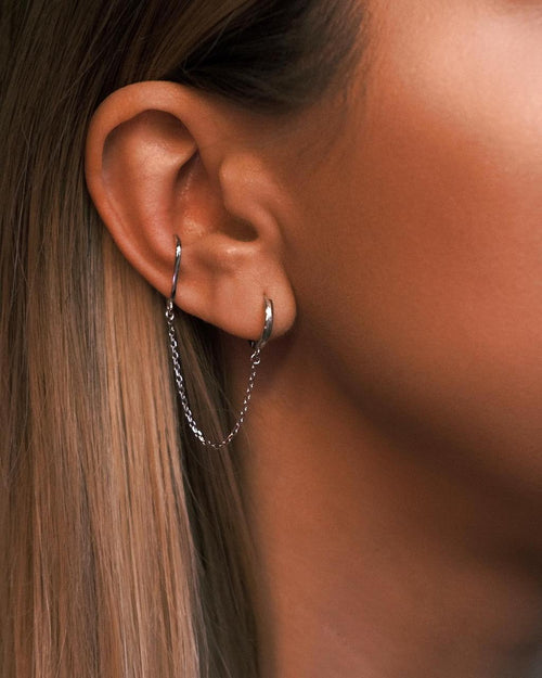 Byzantium Chained Cuff worn, a sterling lobe hoop chained to a cuff higher on the ear